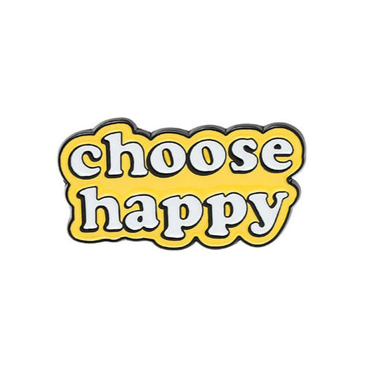 An enamel pin with the text 'choose happy' in a yellow font on a white background.